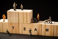 Miniature builders figure with wooden blocks with Ã¢â¬ÅTEAMÃ¢â¬Â wordings